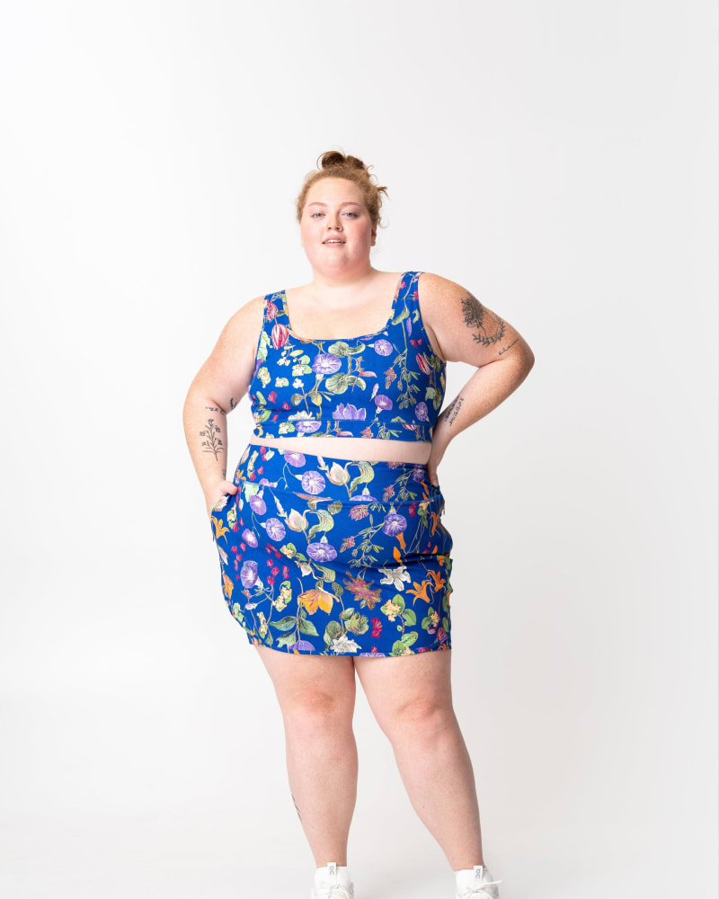 Front of a model wearing a size 5X adventure performance skort in floral by alder apparel. | dia_product_style_image_id:348093